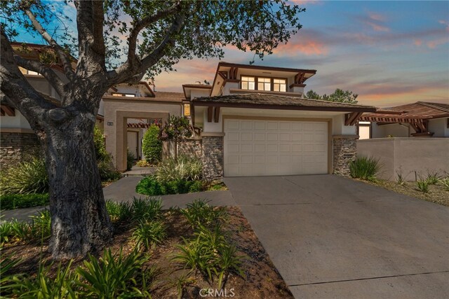27 Birdie Ln, Coto De Caza, CA 92679 - view of front of house with a garage, stucco siding, driveway, and stone siding