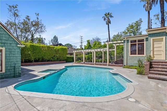 view of swimming pool with a pergola, a pool with connected hot tub, and a patio