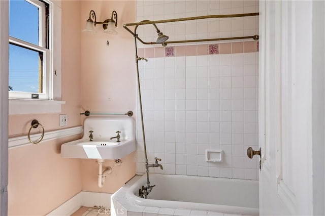 bathroom with shower / tub combination and a sink