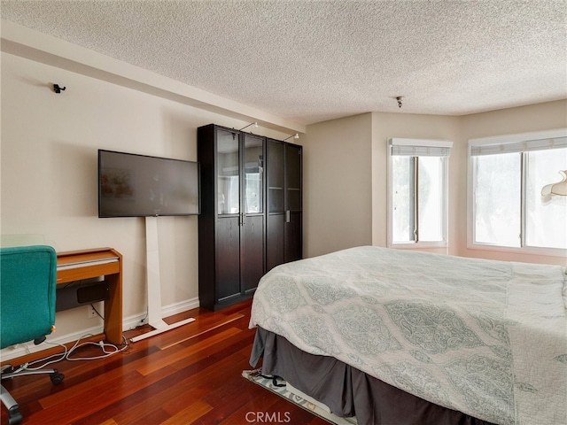 4142 E Mendez St Unit 331, Long Beach, CA 90815 - bedroom featuring dark wood finished floors, a textured ceiling, and baseboards