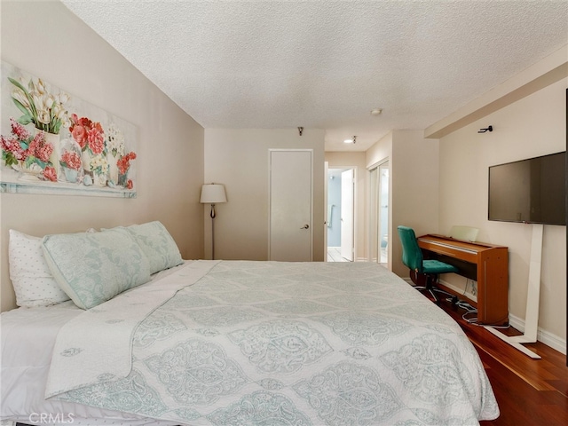 4142 E Mendez St Unit 331, Long Beach, CA 90815 - bedroom featuring wood finished floors, a textured ceiling, and baseboards