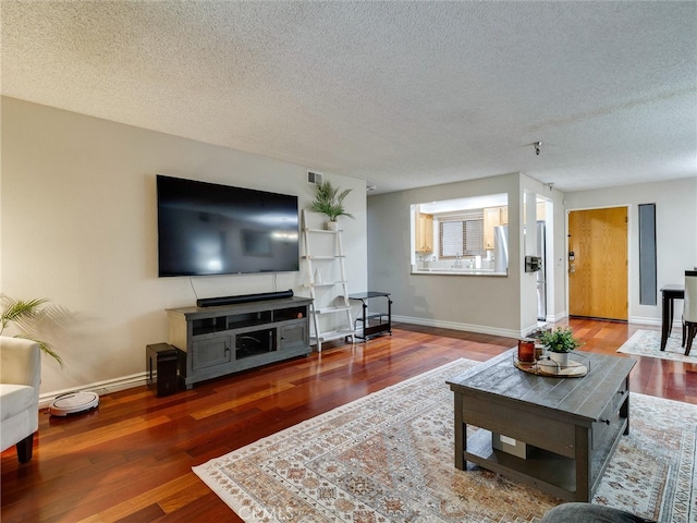 4142 E Mendez St Unit 331, Long Beach, CA 90815 - living area with wood finished floors, a textured ceiling, and baseboards