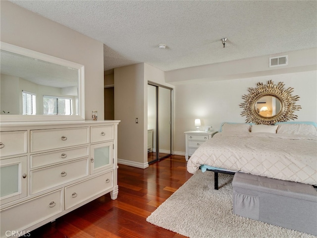 4142 E Mendez St Unit 331, Long Beach, CA 90815 - bedroom with dark wood-type flooring, baseboards, and a textured ceiling