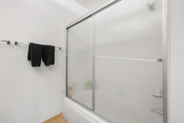 full bathroom featuring shower / bath combination with glass door