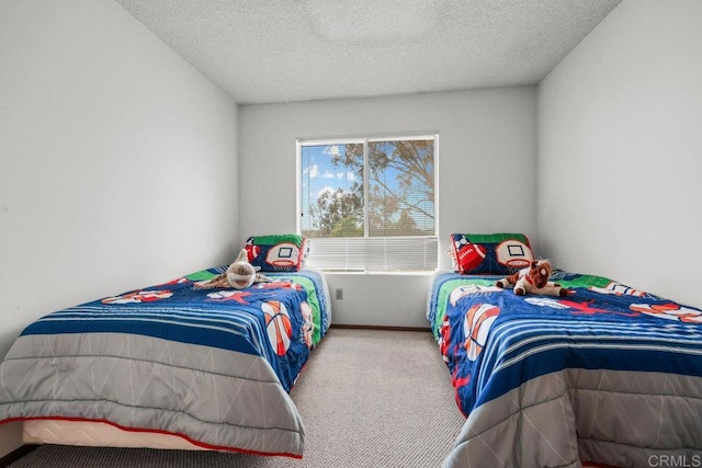 carpeted bedroom with a textured ceiling and baseboards