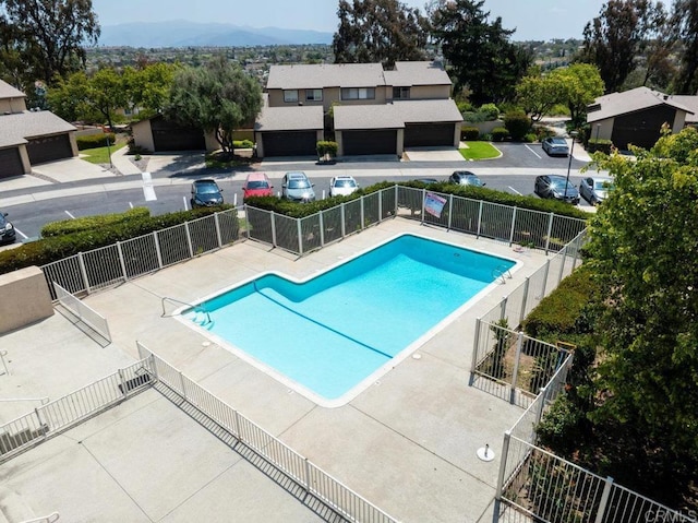 community pool featuring fence and a mountain view