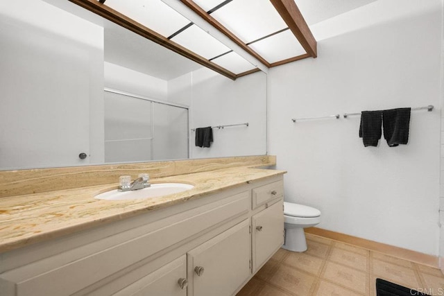 bathroom featuring tile patterned floors, a shower with door, vanity, and toilet