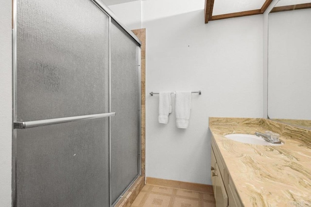 bathroom with vanity, tile patterned floors, and a shower stall