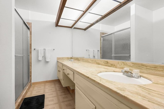 bathroom featuring vanity, tile patterned floors, and a stall shower