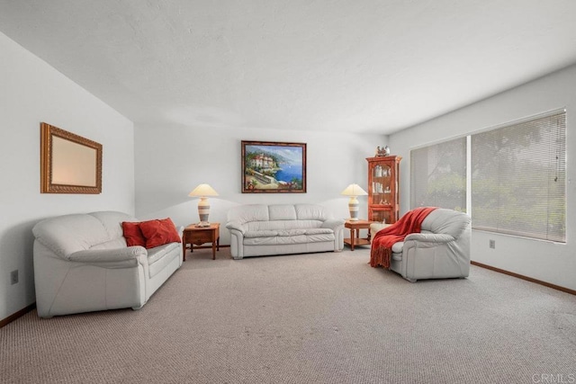 living area featuring carpet floors and baseboards