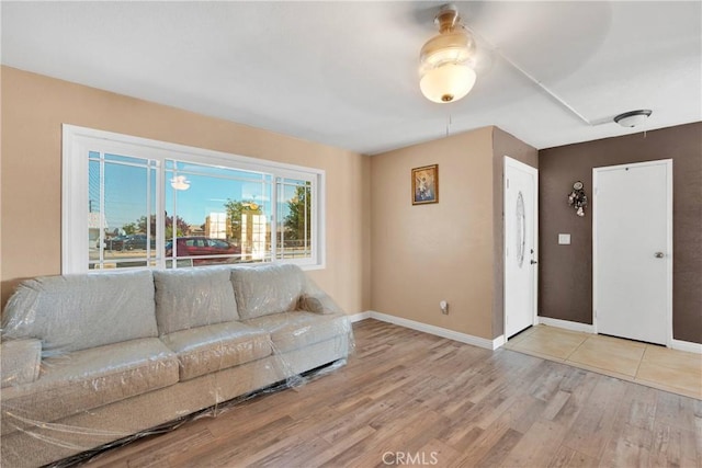 living room with baseboards and wood finished floors