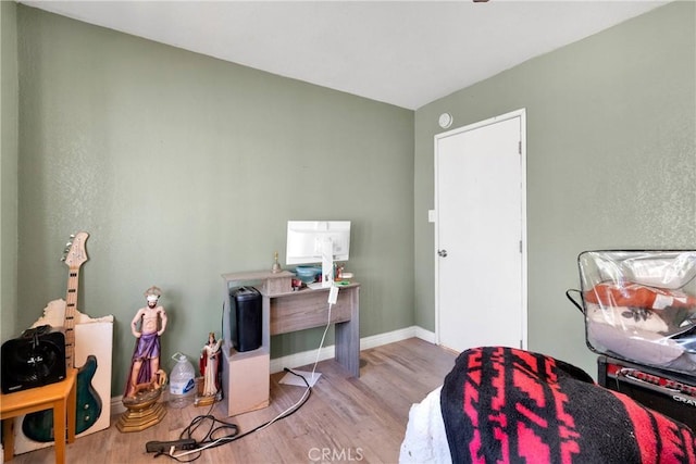 office area featuring baseboards and light wood-style flooring