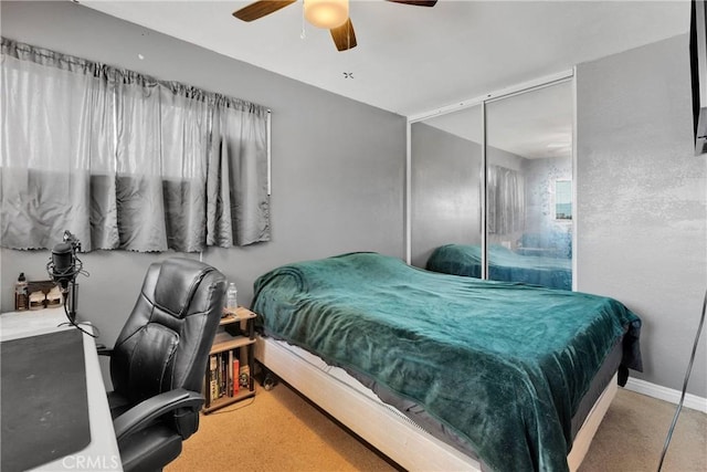 bedroom featuring a ceiling fan, baseboards, carpet, and a closet