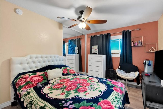 bedroom featuring a ceiling fan and wood finished floors