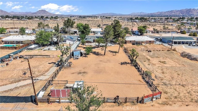 drone / aerial view featuring a rural view, a mountain view, and a desert view