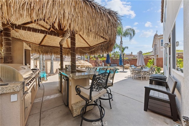 31768 Bottle Brush St, Winchester, CA 92596 - view of patio / terrace featuring a grill, a fenced backyard, an outdoor kitchen, a gazebo, and outdoor dining space