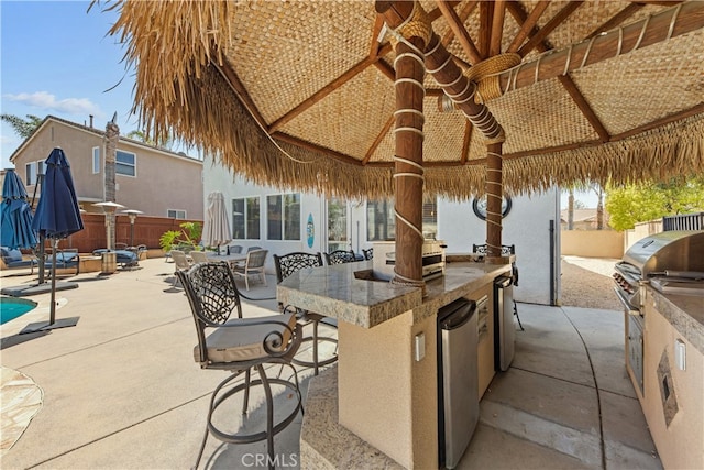 31768 Bottle Brush St, Winchester, CA 92596 - view of patio / terrace featuring an outdoor kitchen, a gazebo, a fenced backyard, and outdoor wet bar