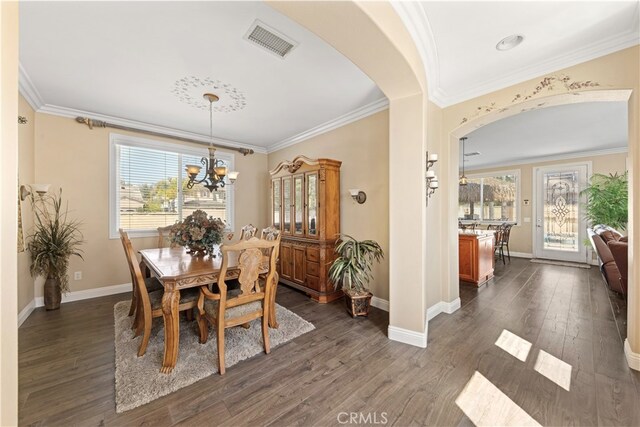 31768 Bottle Brush St, Winchester, CA 92596 - dining space with visible vents, arched walkways, dark wood finished floors, a notable chandelier, and ornamental molding