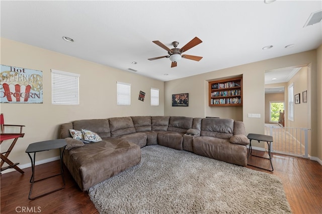31768 Bottle Brush St, Winchester, CA 92596 - living area with baseboards, ceiling fan, dark wood finished floors, and visible vents