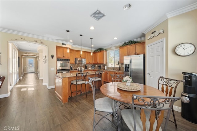 31768 Bottle Brush St, Winchester, CA 92596 - dining space featuring arched walkways, baseboards, visible vents, and dark wood-style floors