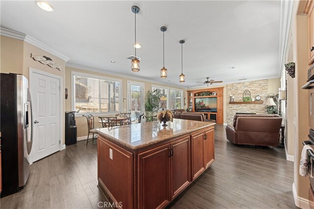 31768 Bottle Brush St, Winchester, CA 92596 - kitchen featuring crown molding, light stone countertops, dark wood finished floors, freestanding refrigerator, and baseboards