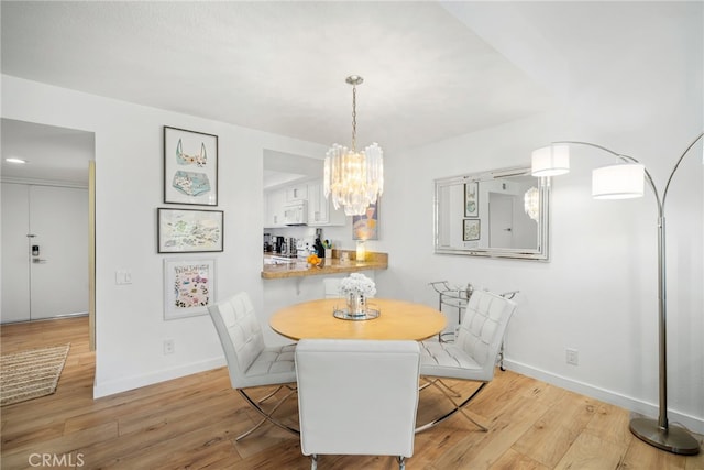 60 La Ronda Dr, Rancho Mirage, CA 92270 - dining room featuring light wood-style floors, baseboards, and a chandelier