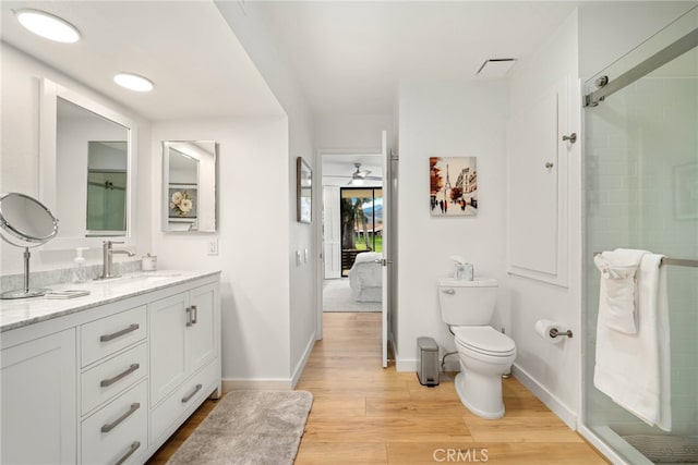 60 La Ronda Dr, Rancho Mirage, CA 92270 - ensuite bathroom featuring connected bathroom, vanity, toilet, baseboards, and wood finished floors