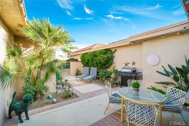 60 La Ronda Dr, Rancho Mirage, CA 92270 - view of patio featuring area for grilling, fence, and outdoor dining space