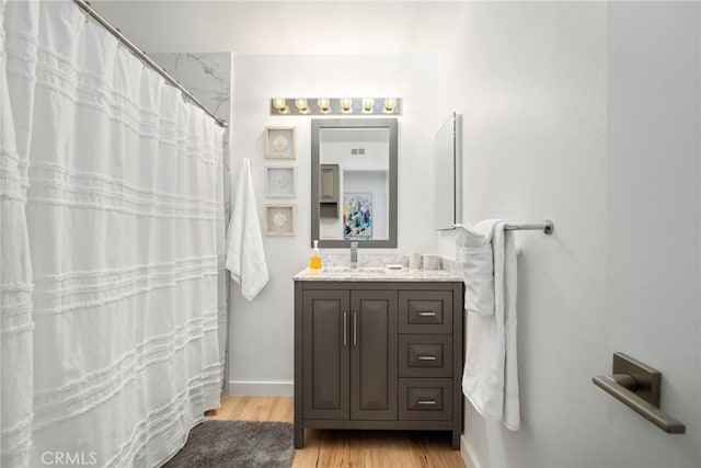 60 La Ronda Dr, Rancho Mirage, CA 92270 - bathroom featuring vanity, baseboards, wood finished floors, a shower with curtain, and visible vents