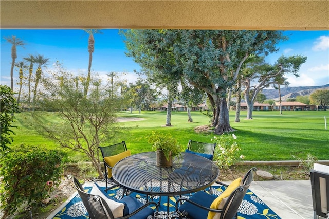 60 La Ronda Dr, Rancho Mirage, CA 92270 - view of patio with view of golf course, a mountain view, and outdoor dining space