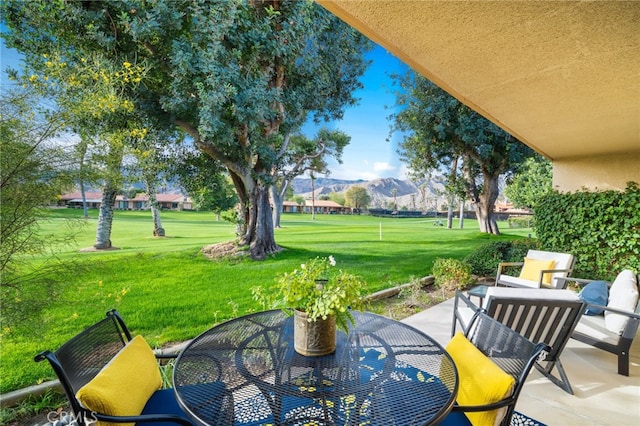 60 La Ronda Dr, Rancho Mirage, CA 92270 - view of patio with a mountain view and outdoor dining space