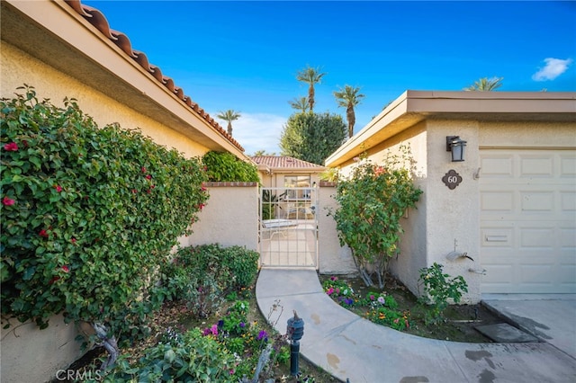 60 La Ronda Dr, Rancho Mirage, CA 92270 - view of side of home featuring a gate and stucco siding