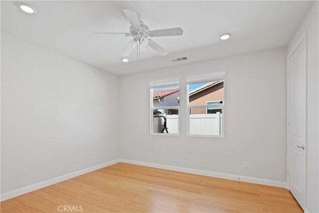 spare room featuring light wood-style floors, baseboards, recessed lighting, and visible vents