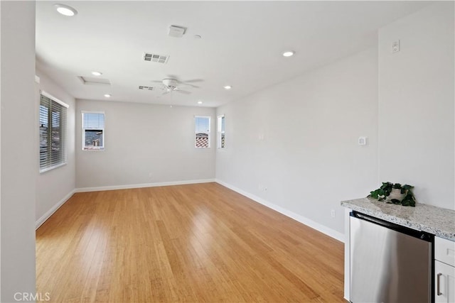 unfurnished room with light wood-style floors, recessed lighting, baseboards, and visible vents