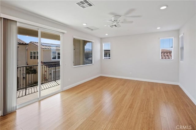 unfurnished room with a ceiling fan, baseboards, visible vents, and wood finished floors