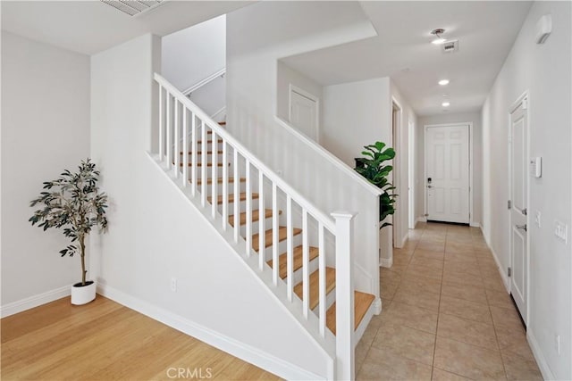 stairs featuring baseboards, recessed lighting, tile patterned flooring, and visible vents