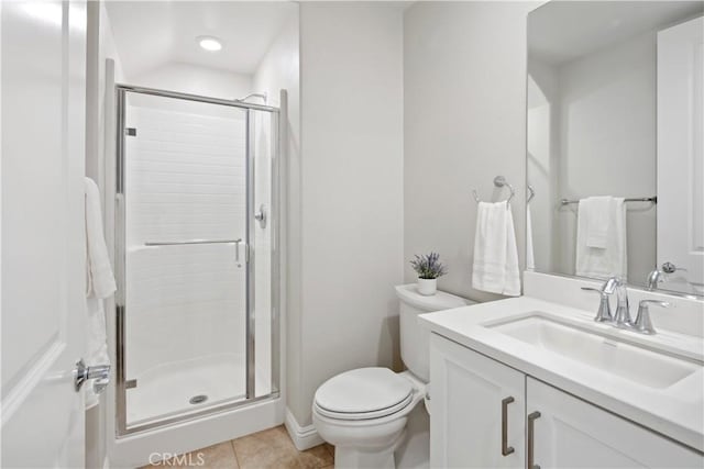 bathroom featuring vanity, tile patterned floors, a shower stall, and toilet