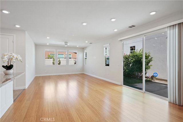 unfurnished living room featuring recessed lighting, baseboards, visible vents, and light wood finished floors