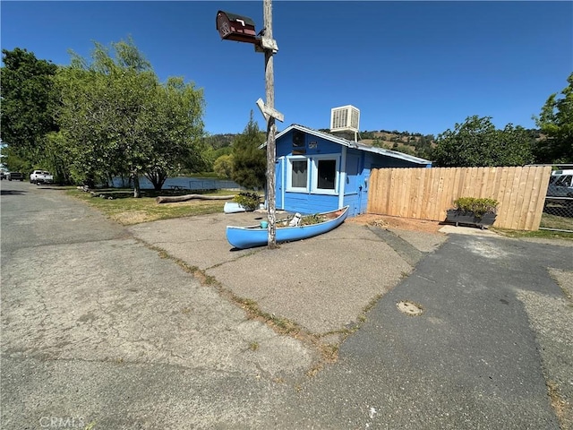 exterior space with central AC and fence