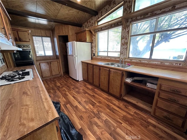 kitchen featuring white appliances, brown cabinets, wooden ceiling, a sink, and dark wood finished floors