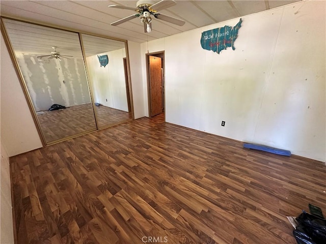 unfurnished bedroom featuring ceiling fan, a closet, and wood finished floors
