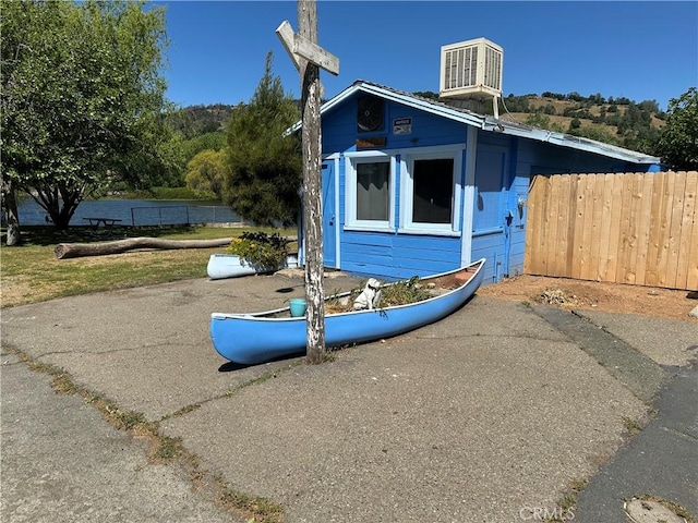 view of home's exterior featuring fence and cooling unit
