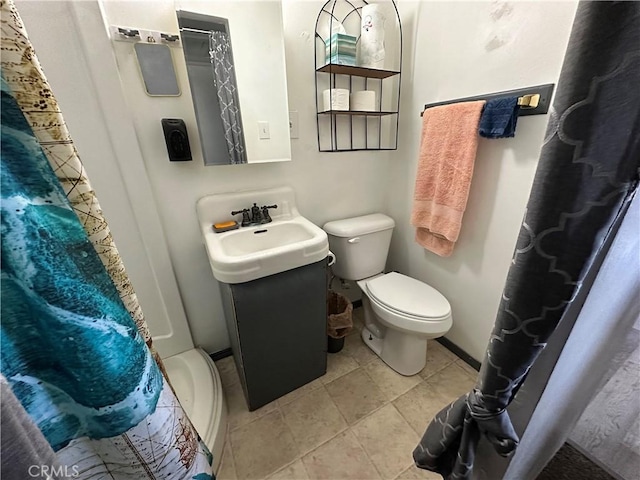 bathroom featuring toilet, tile patterned floors, a shower with curtain, and vanity