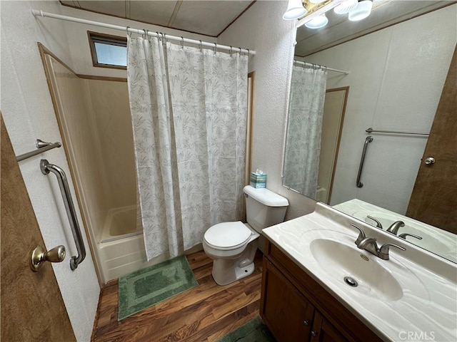 bathroom with vanity, shower / bath combo with shower curtain, a textured wall, wood finished floors, and toilet