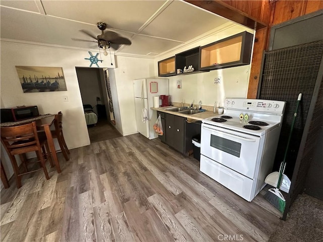 kitchen with a ceiling fan, dark wood finished floors, a sink, light countertops, and white appliances