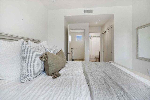 bedroom with ensuite bath and visible vents