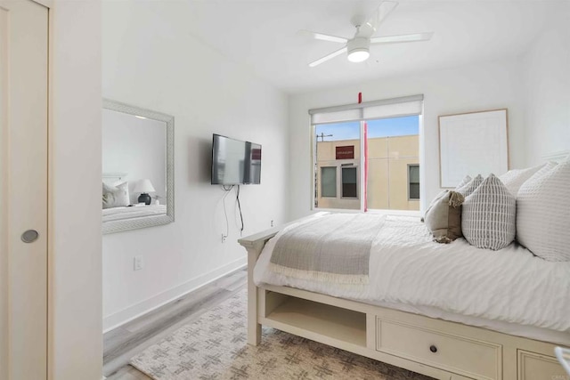 bedroom featuring baseboards, ceiling fan, and wood finished floors