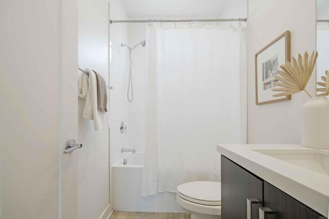 bathroom with vanity, shower / bath combo, and toilet