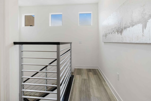 stairway featuring baseboards and wood finished floors