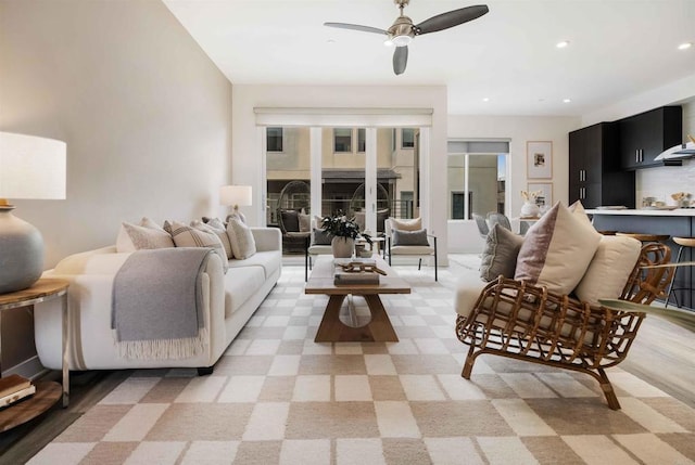 living area featuring recessed lighting and ceiling fan